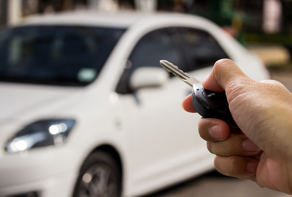 Experienced auto locksmith in Springfield, MO duplicating a car key with precision on a modern key-cutting machine.