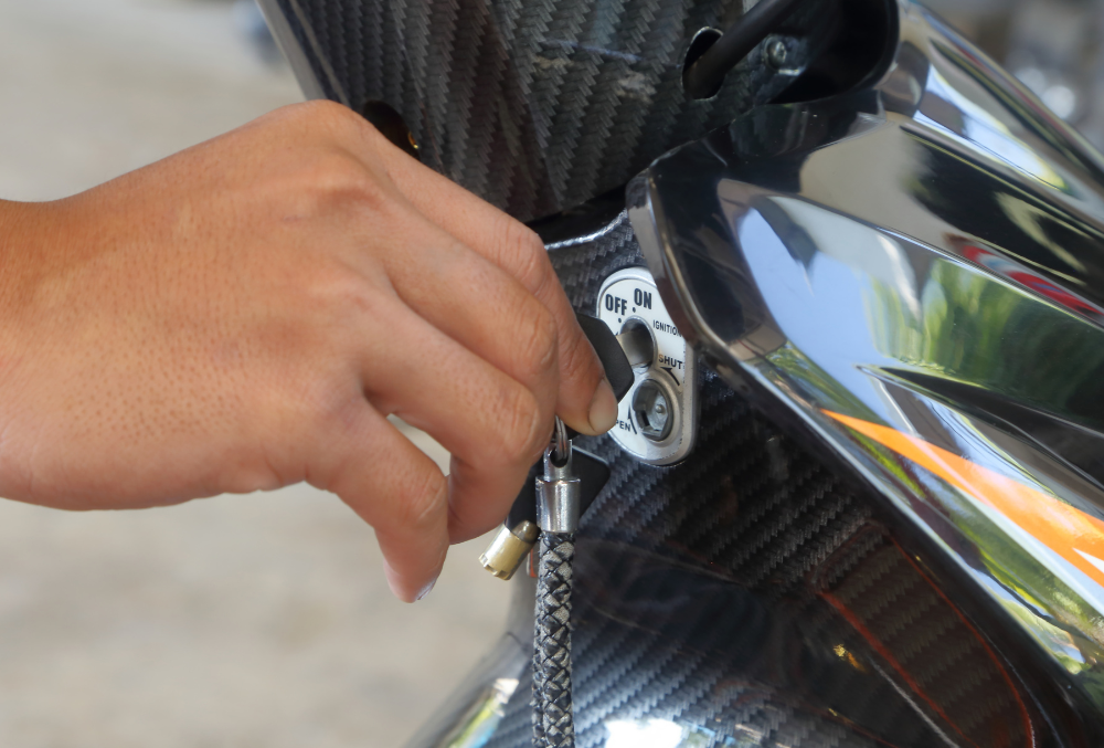 Motorcycle locksmith in Jacksonville, NC creating a replacement key for a Harley-Davidson.